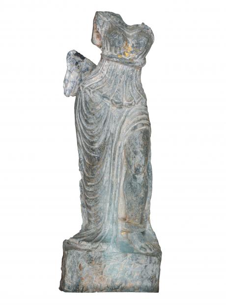 <h3>Aphrodite-type statuette</h3>  <p>Schist<br>1st Century CE.<br>Dharmarajika<br>H: 38cm<br>This fragmentary statuette with remnants of gold-leaf on the chest and the anklet, exemplifies the hybridized character of Gandharan art. The female figure wears a chiton with well-articulated folds, recalling Classical sculptural representations of Aphrodite, the Greek goddess of love and beauty.</p>