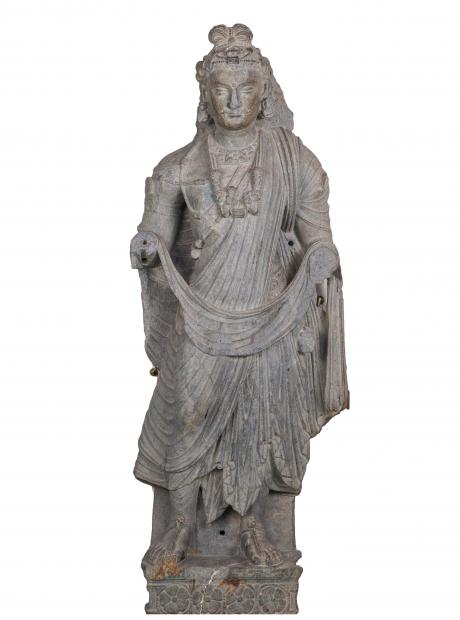 <h3>Bodhisattva Maitreya</h3>  <p>Grey schist<br /> Mohra Moradu, Taxila<br /> 2nd – 3rd Century CE.<br /> 100 x 37 x 17 cm<br /> A half-lifesize devotional icon of Bodhisattva Maitreya standing on a pedestal with rosettes carved in low relief. The sculpture is identified as Maitreya on the basis of certain iconographic attributes such as the gesture of the missing right hand raised in abhaya and the flask held in the left hand (now missing).</p>