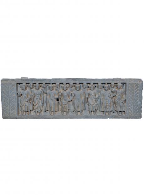 <h3>Buddha and Bodhisattva</h3> <p>Grey Schist<br /> 1st – 2nd Century AD<br /> Nowshera Collection<br /> A relief panel depicting a row of three standing Buddhas and three standing Bodhisattvas, alternating, flanked by two devotees holding lotus buds and garlands. The figures are shown in various ritual gestures and carved naturalistically with close attention to detail.</p>